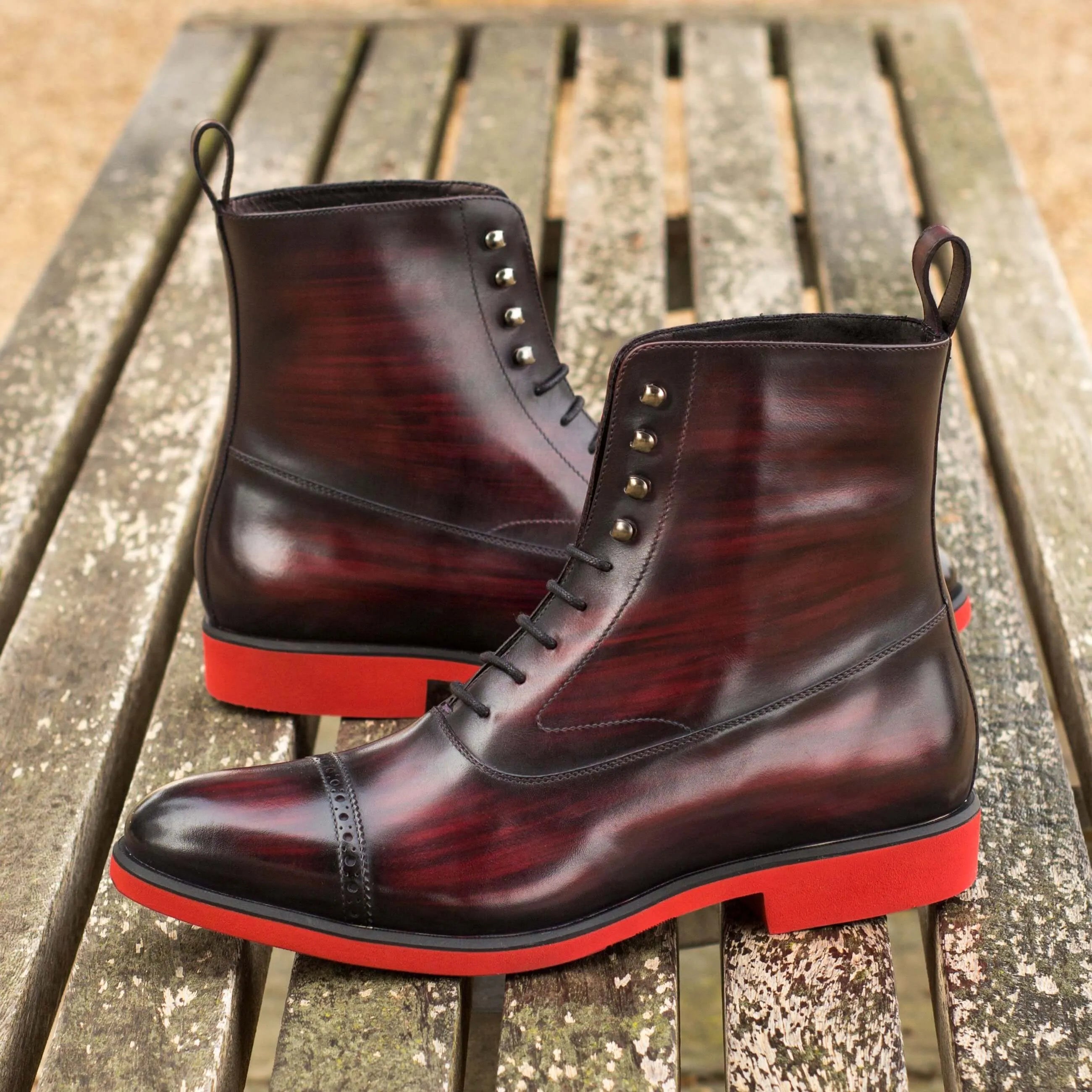 B61 balmoral patina boots in burgundy leather with red soles