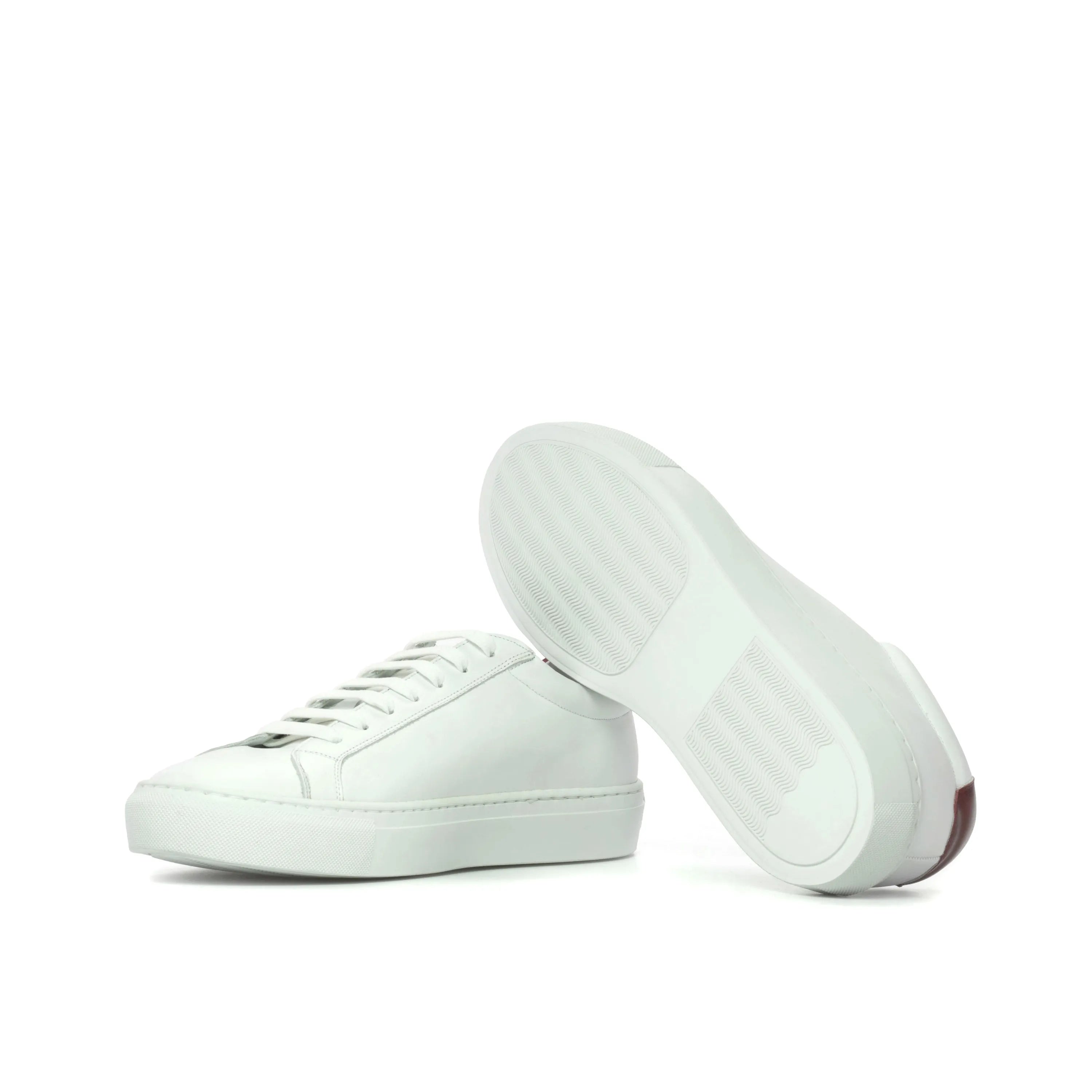 Pair of white leather Sima low kick sneakers in fast lane style